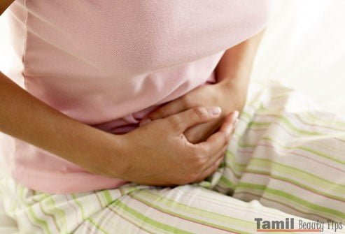 photolibrary rm photo of woman holding stomach